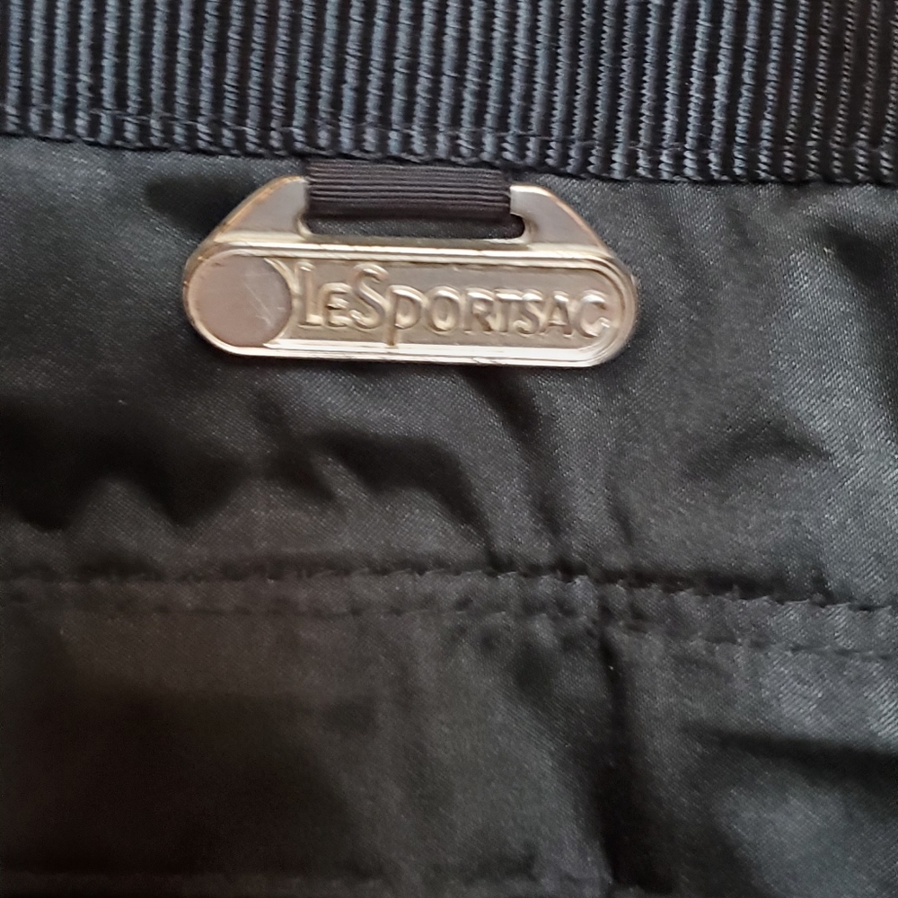 A Black Lesportsac over night bag lined.